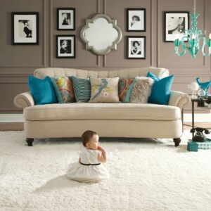 Cute baby sitting on carpet floor | Bodamer Brothers Flooring